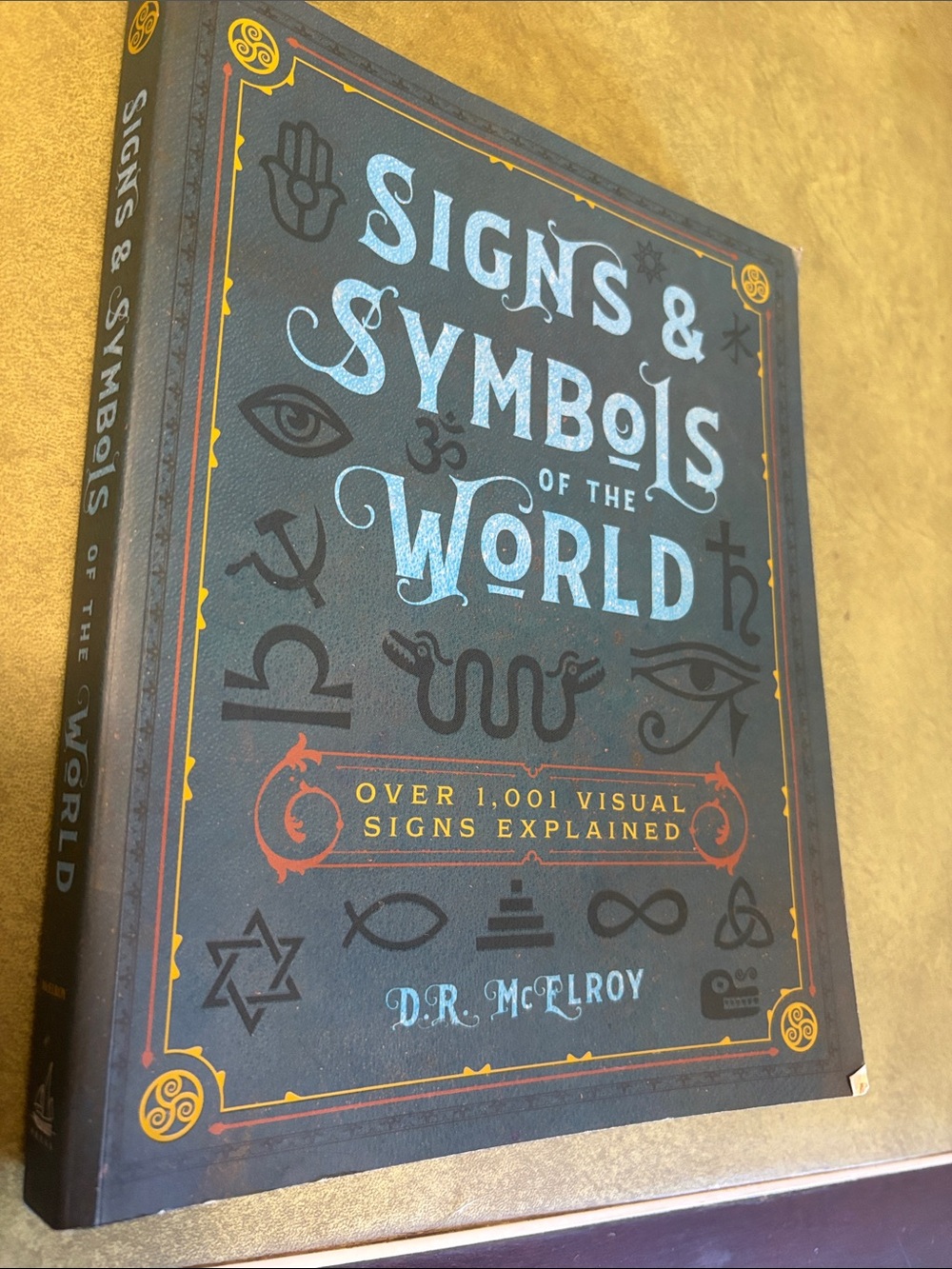 Signs & Symbols of the World — Blue Hardcover by D.R. McElroy
